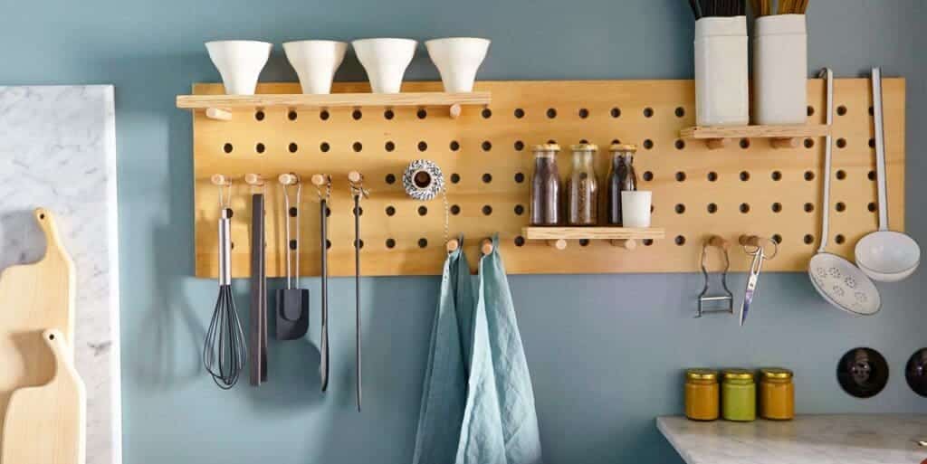 wall mounted cabinet in the kitchen and kitchen tools are hanging in this cabinet