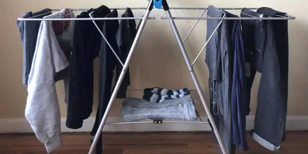 A view of clothes and shoes hung on the clothes drying rack