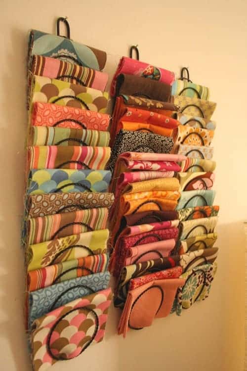 A view of colorful fabrics hanged by the wall hanger