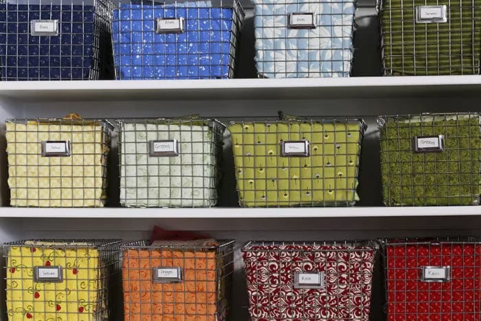 A view of colorful fabrics stored inside a wired basket