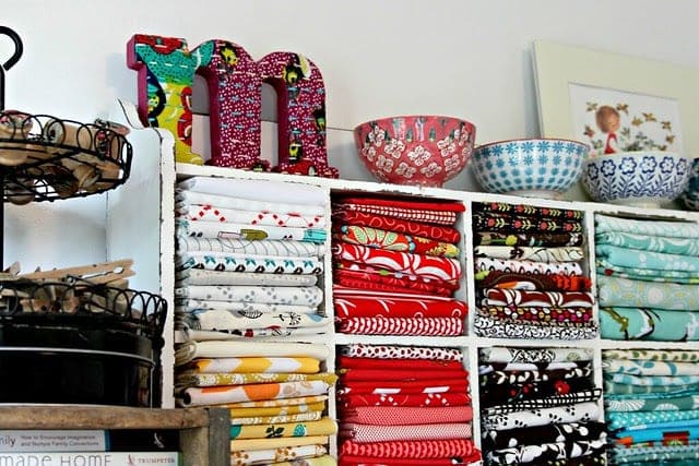 A view of fabrics displayed in an open shelf by colors