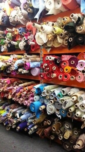 A view of fabrics rolled and stored inside a rack