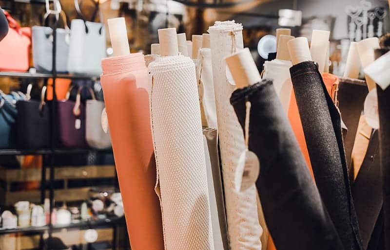 A view of fabrics rolled onto a paper towel holder