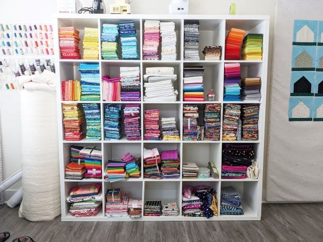 A view of of a smart shelf organization with fabrics stored inside