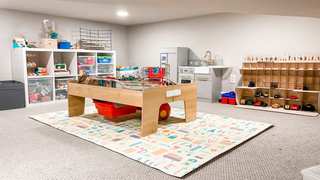 crawl space door a table and shelves in a playroom for arranging toys