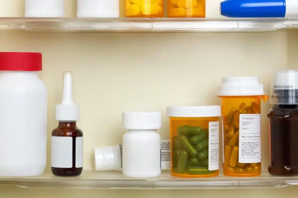 different pills and syrups placed in a cool surface in a cabinet