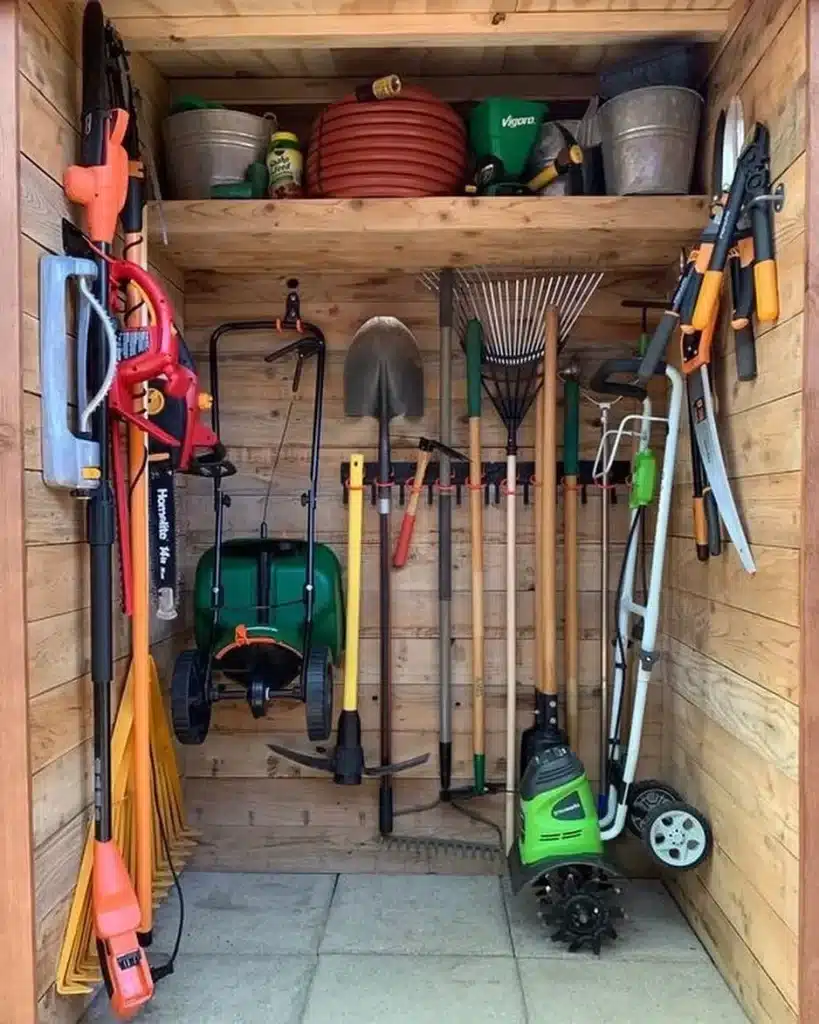 overhead garden tool storage in a wooden shed different tools set up in it pipes to buckets and lawn mowers etc