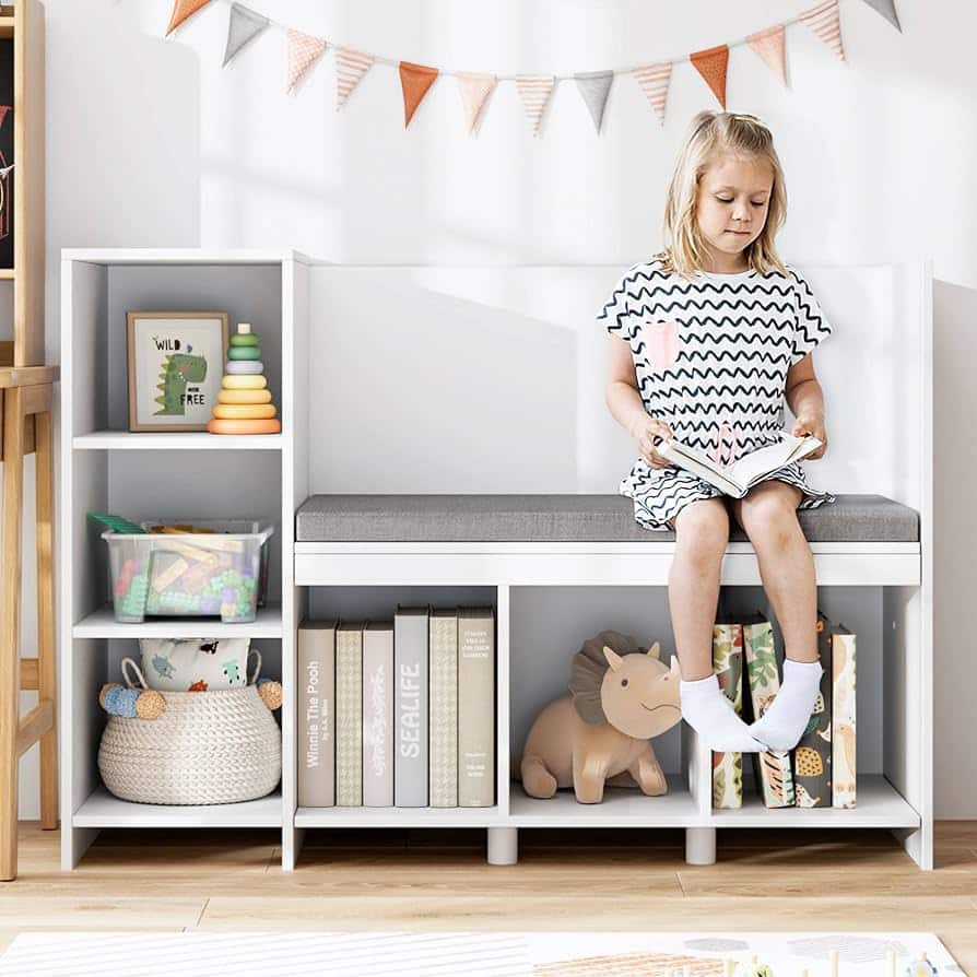 storage bench with toys in it a kid sitting on it