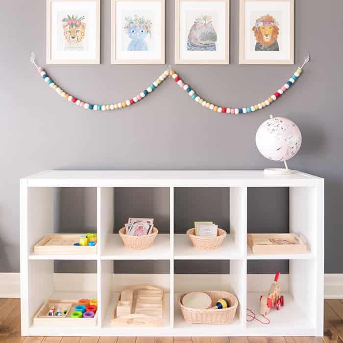 toy rotation with toys placed in basket artwork on wall