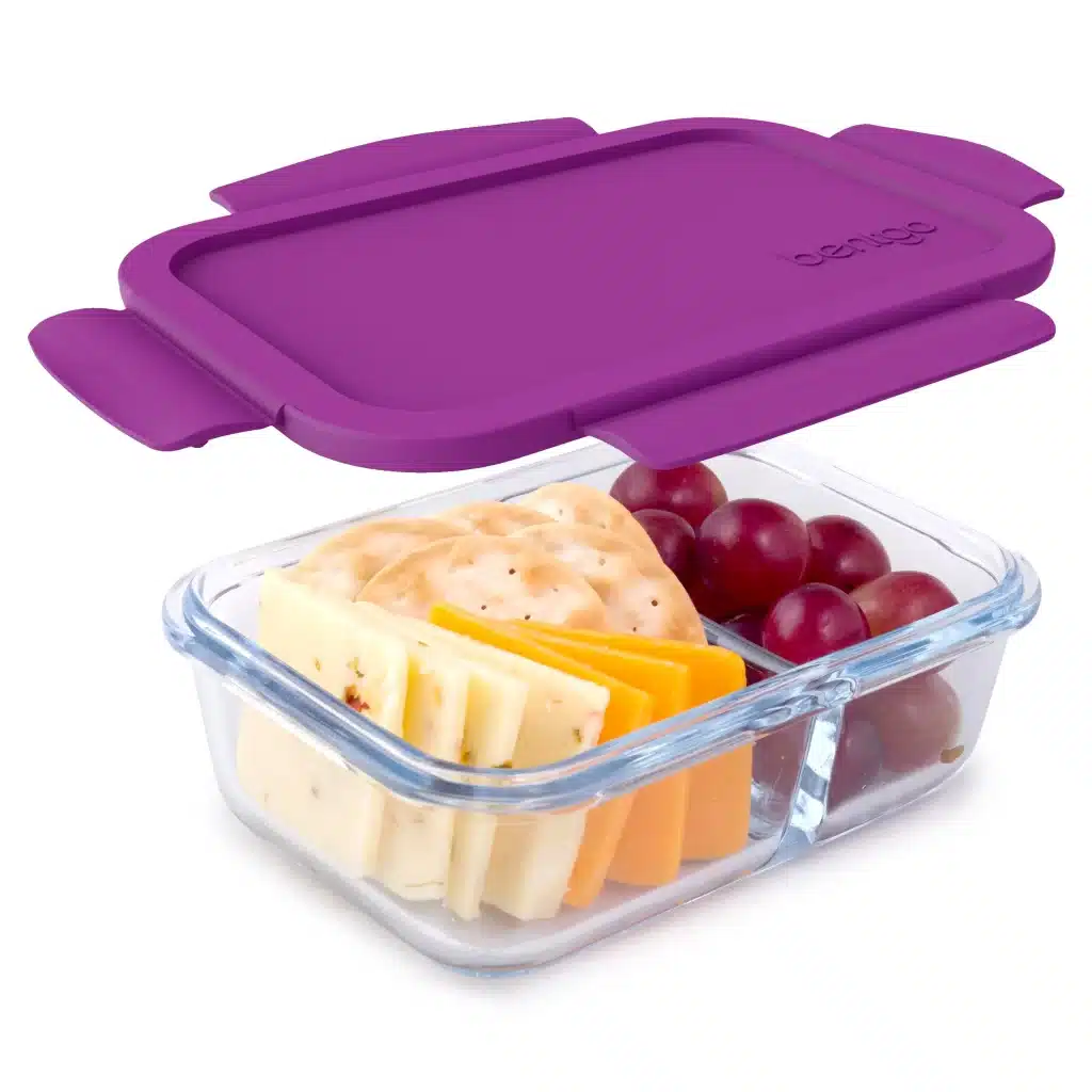 A view of a Bentgo Glass Leak Proof Storage Container with grapes and crackers and a purple lid