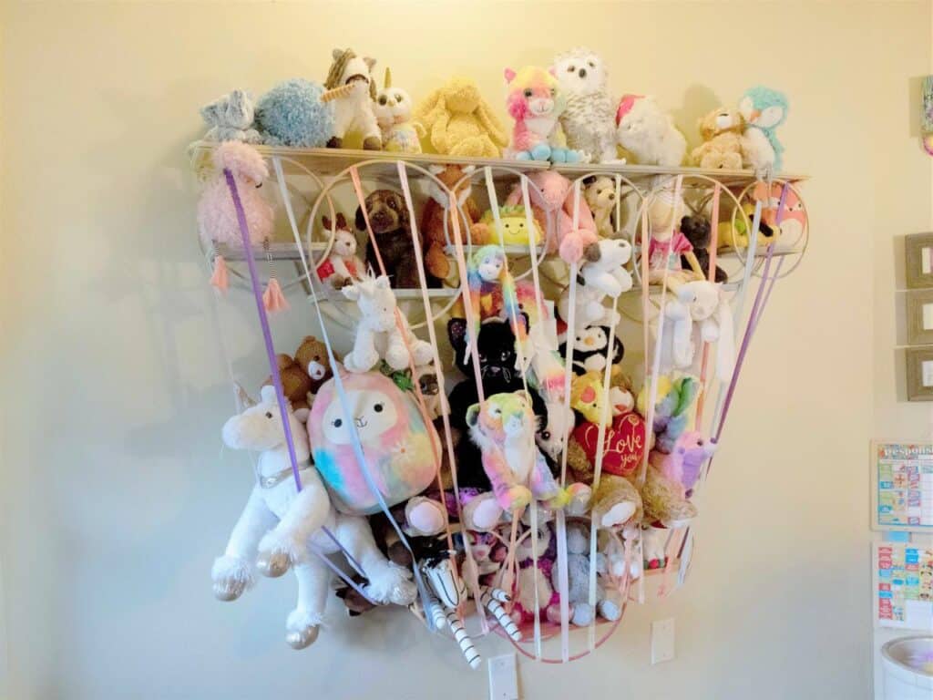 DIY wall mounted rack with a lot of stuffed animals