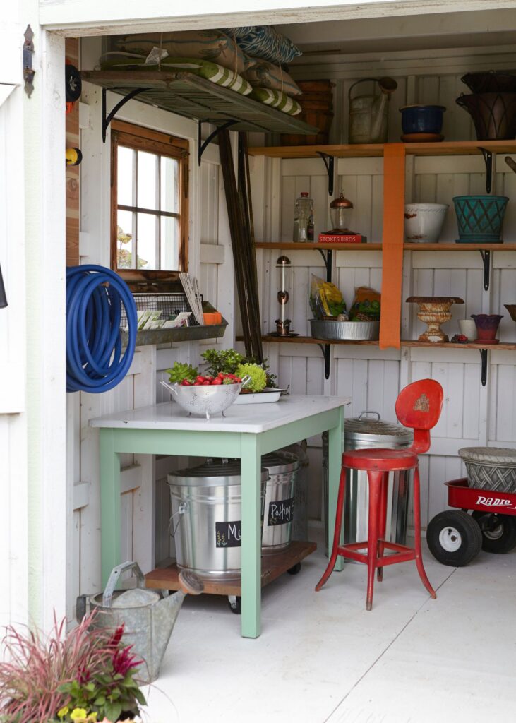 different items arranged in a shed on shelves and under the table