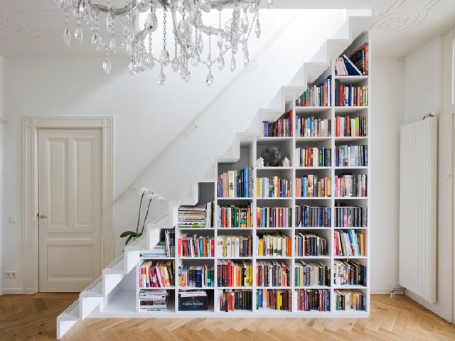 plenty of books stored under stairs