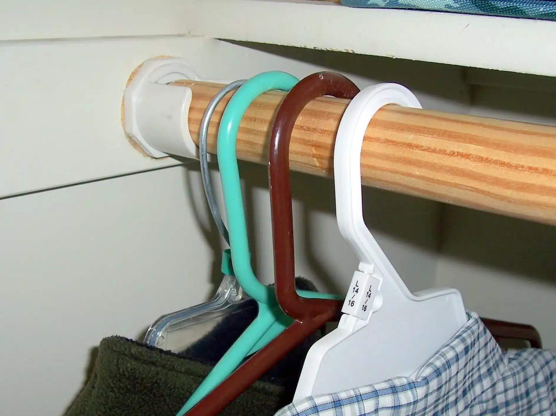 A close view of hangers hung from a closet rod