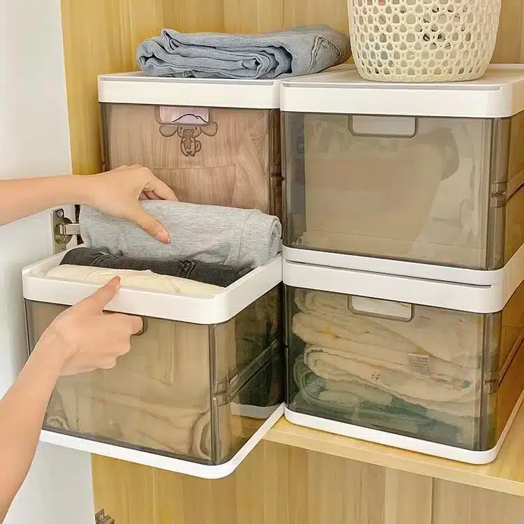 A view of clothes folded inside clear storage bins