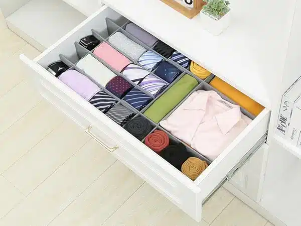 A view of clothes rolled and arranged inside a drawer