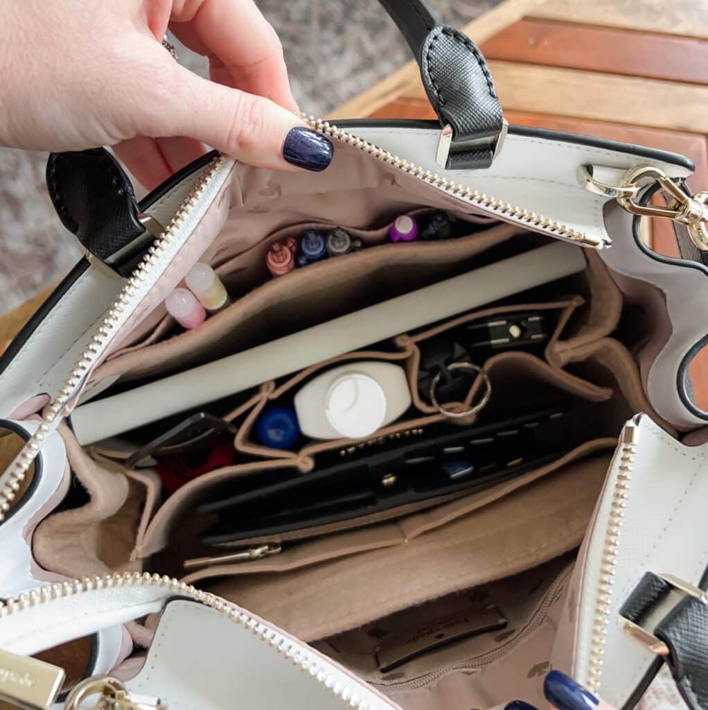 A top view of a purse with items stored in inserts