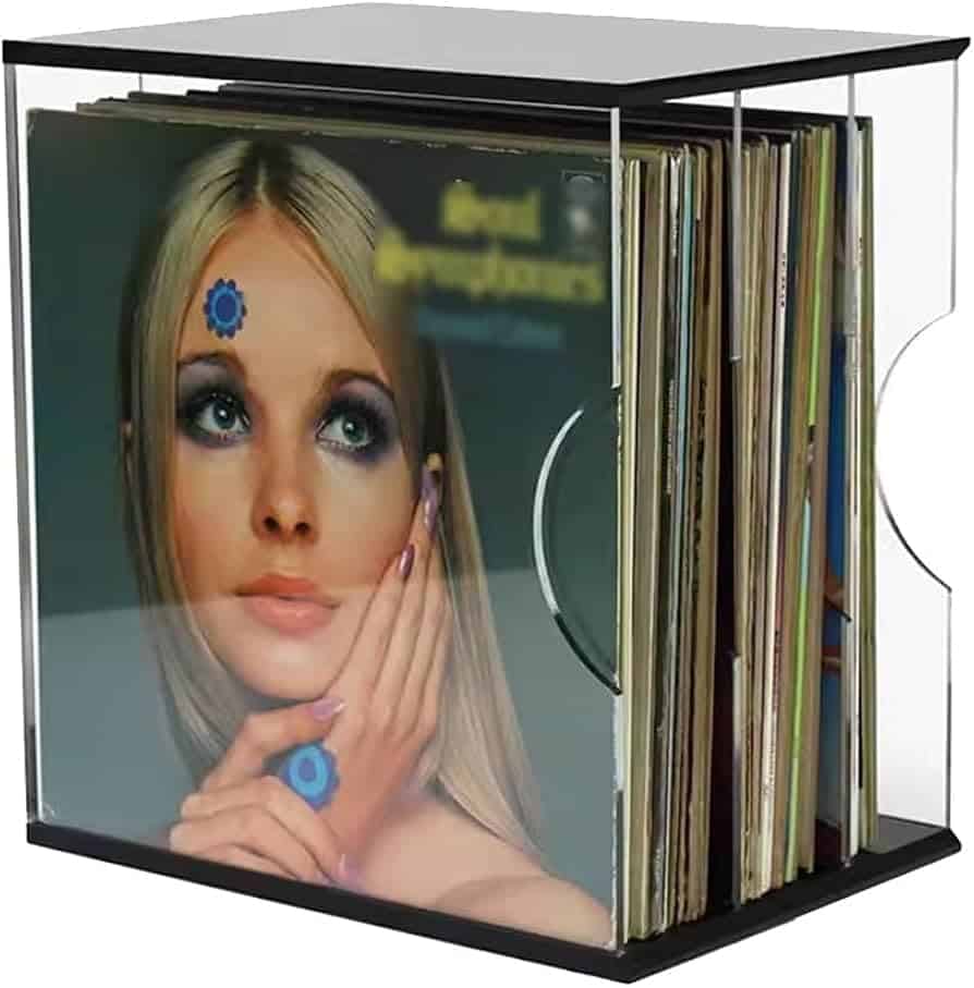 A view of a collection of vinly records stored inside an acrylic holder