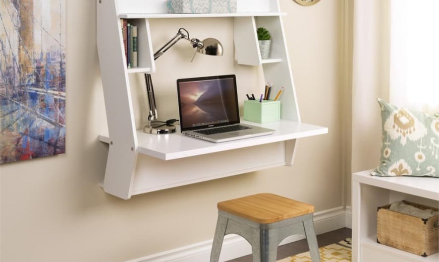 A view of a wall mounted desk with items on it inside a bedroom