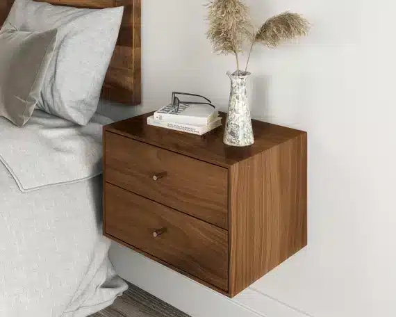 A view of a wooden floating nightstand by a bedside