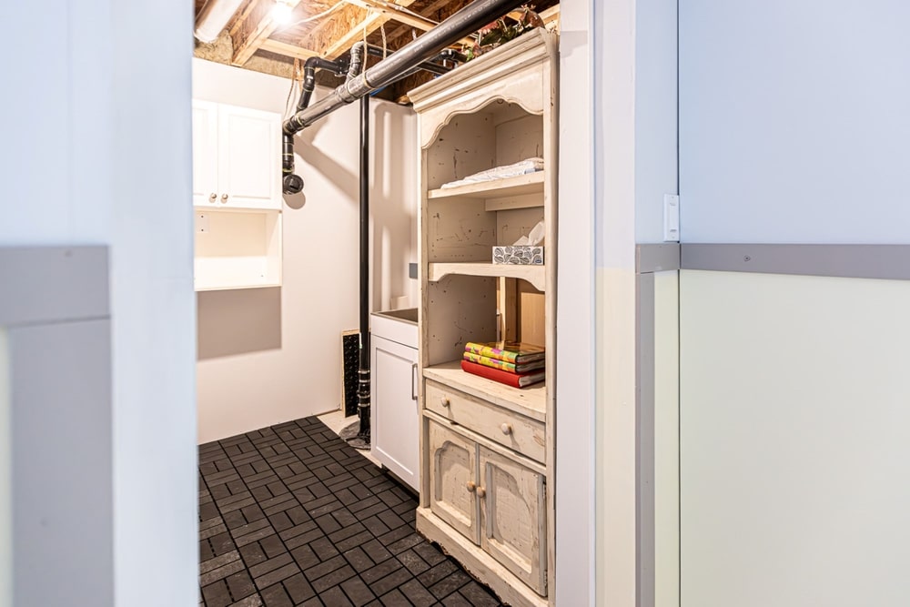 A view of an open shelving unit inside a basement space 