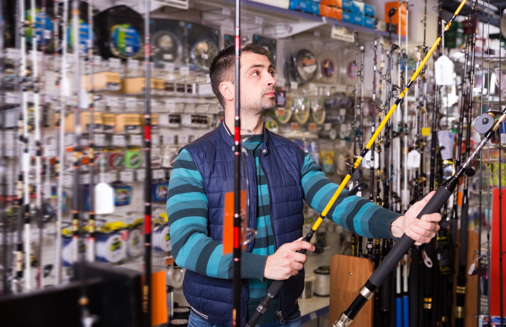 A view of a guy holding fishing rods