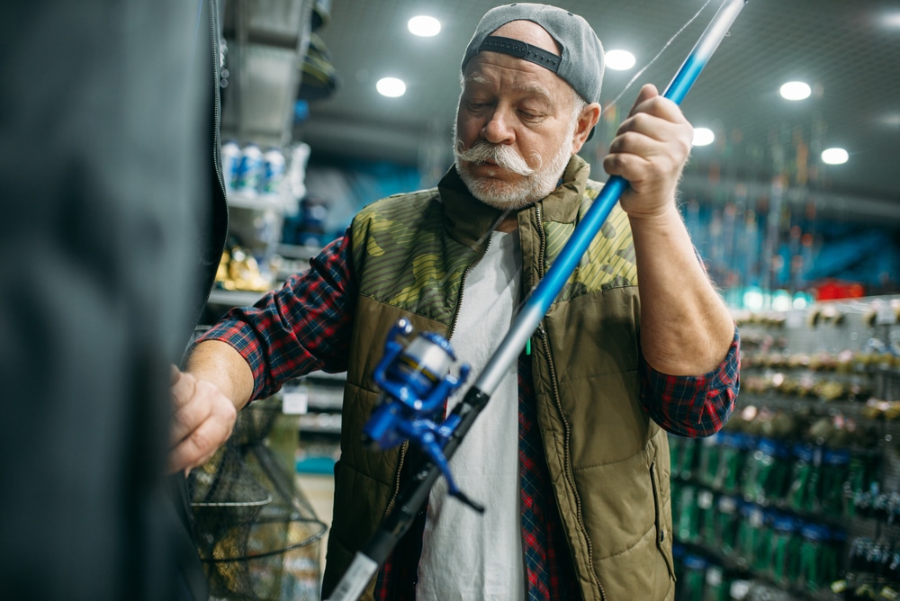 A view of an old man holding a rod inside a garage space