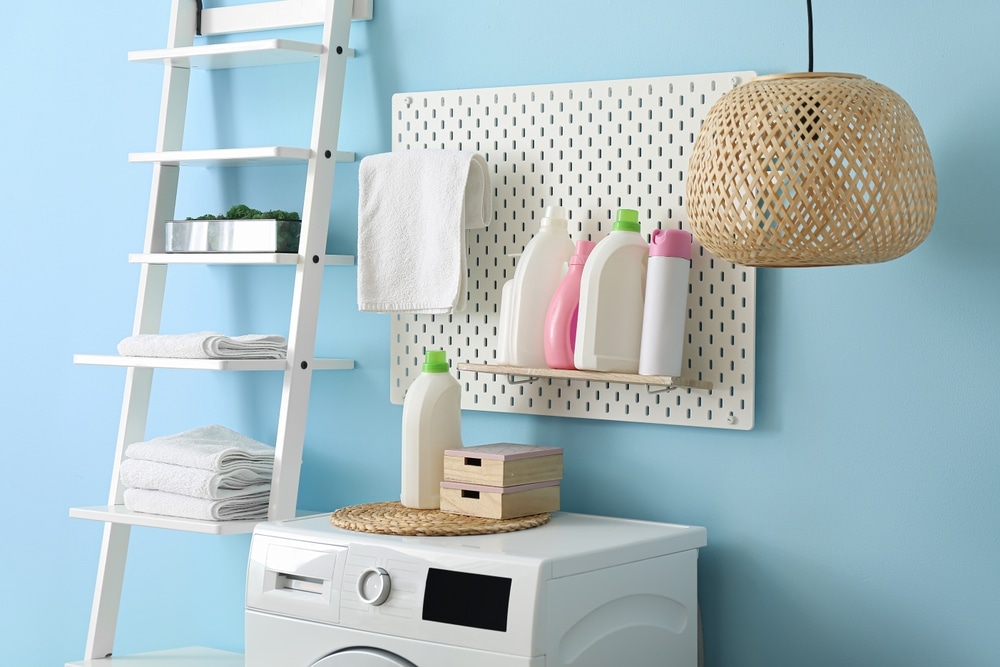 A view of a washer with detergents and other items stored