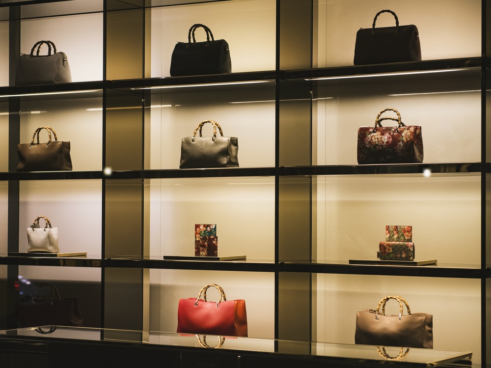 A view of a glass display with purses in it