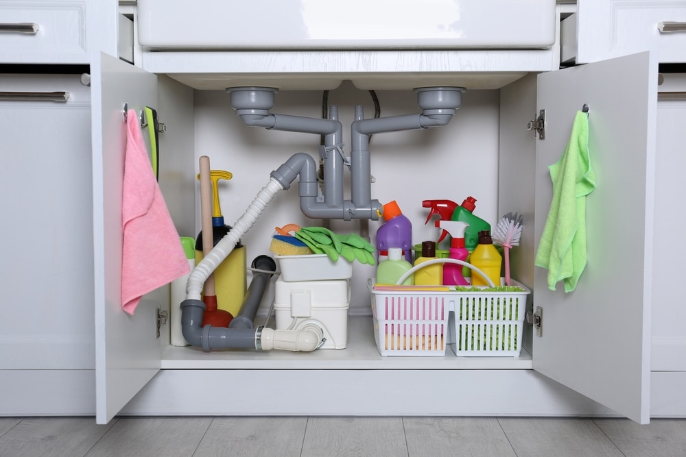 A view of things stored inside a kitchen under sink cabinet